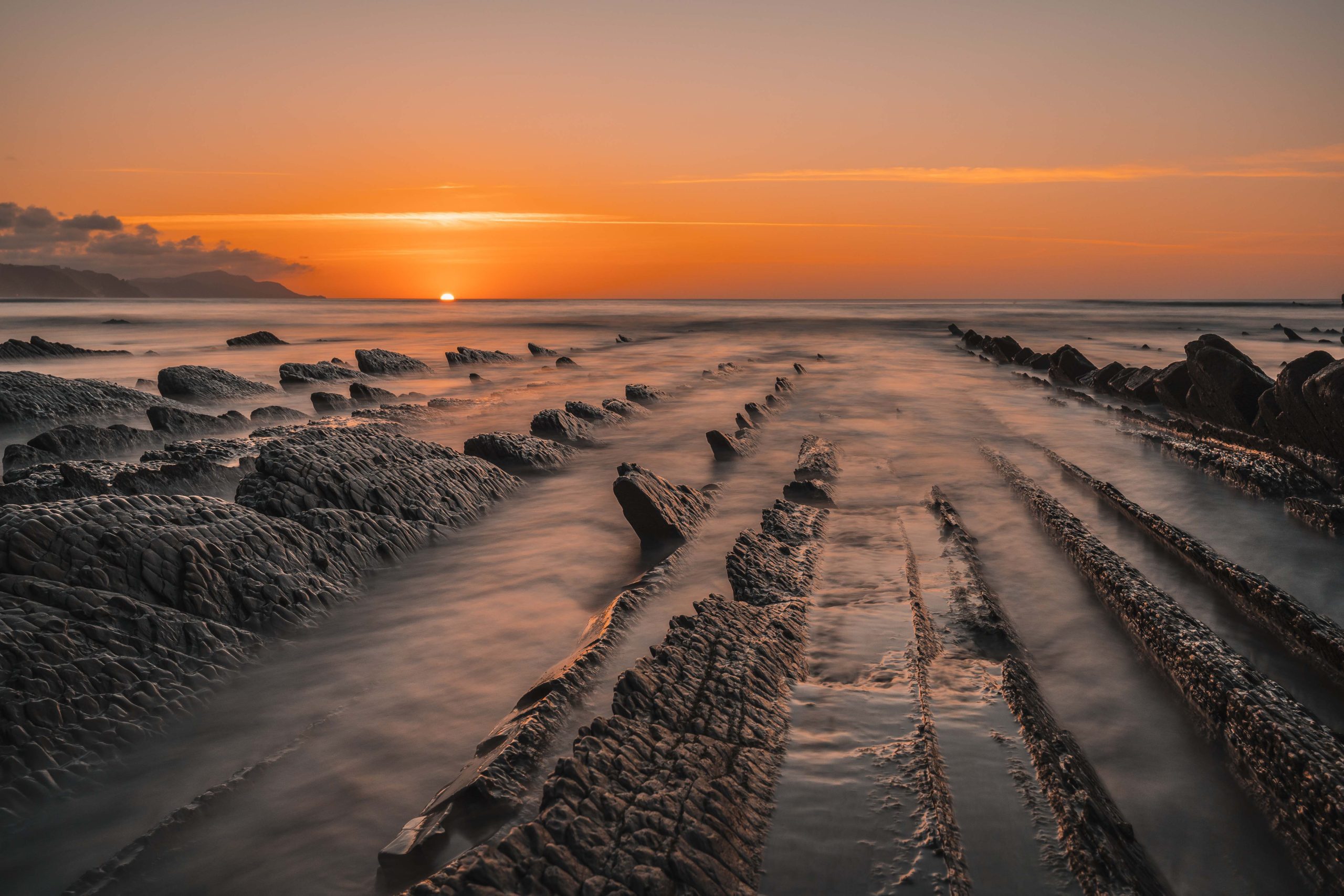 View of the beautiful orange sunset on the flysch of the Sakoneta beach