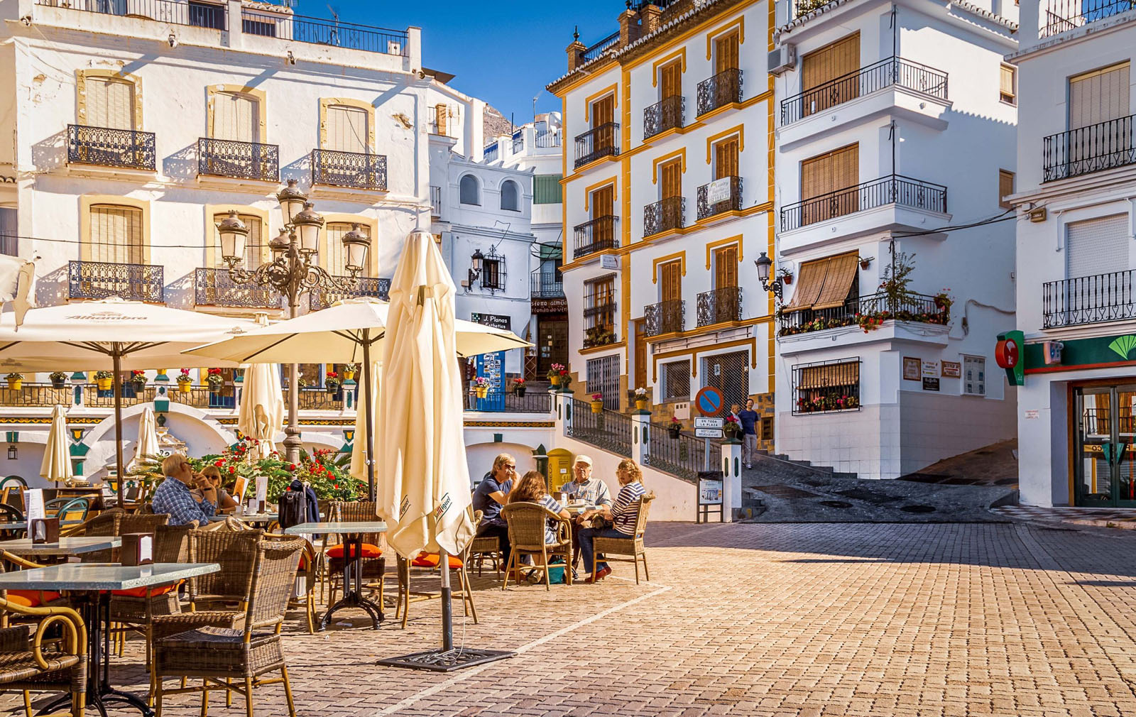 People enloying the summer at Central Plaza at city Competa, Andalusia, Spain