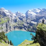 Hiker Admiring Oeschinen Lake in Switzerland
