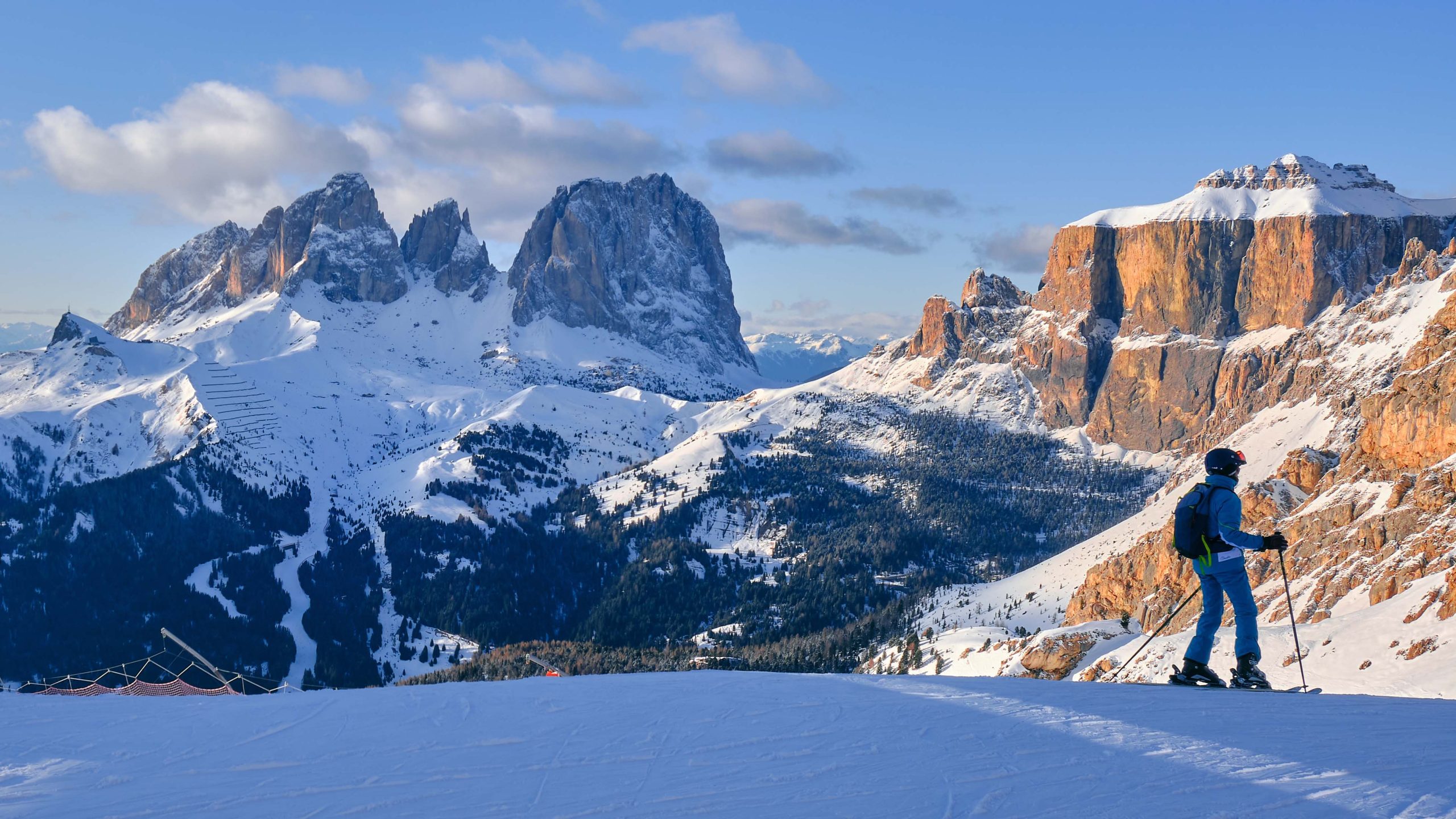 Ski domain Dolomiti Superski with panoramic views of Sassolungo and Sella group, at sunset.