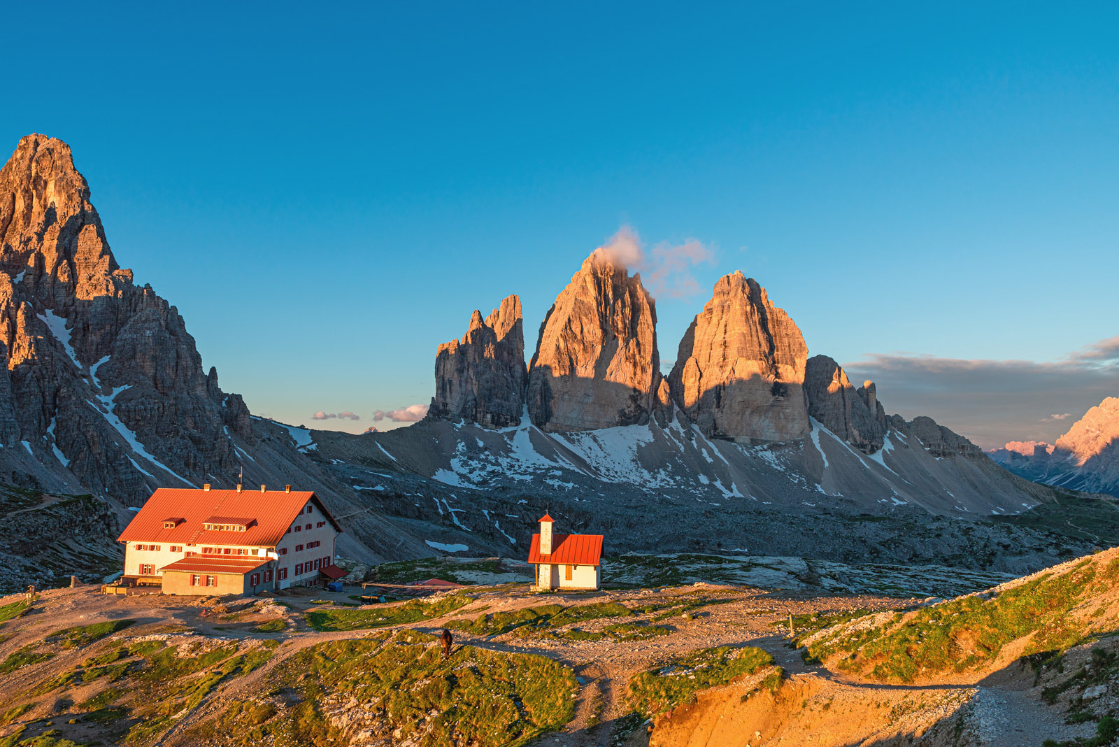 Panoramic sunrise view of Tre cime di Lavaredo mountain peaks in the Dolomites or Dolomiti, Italy