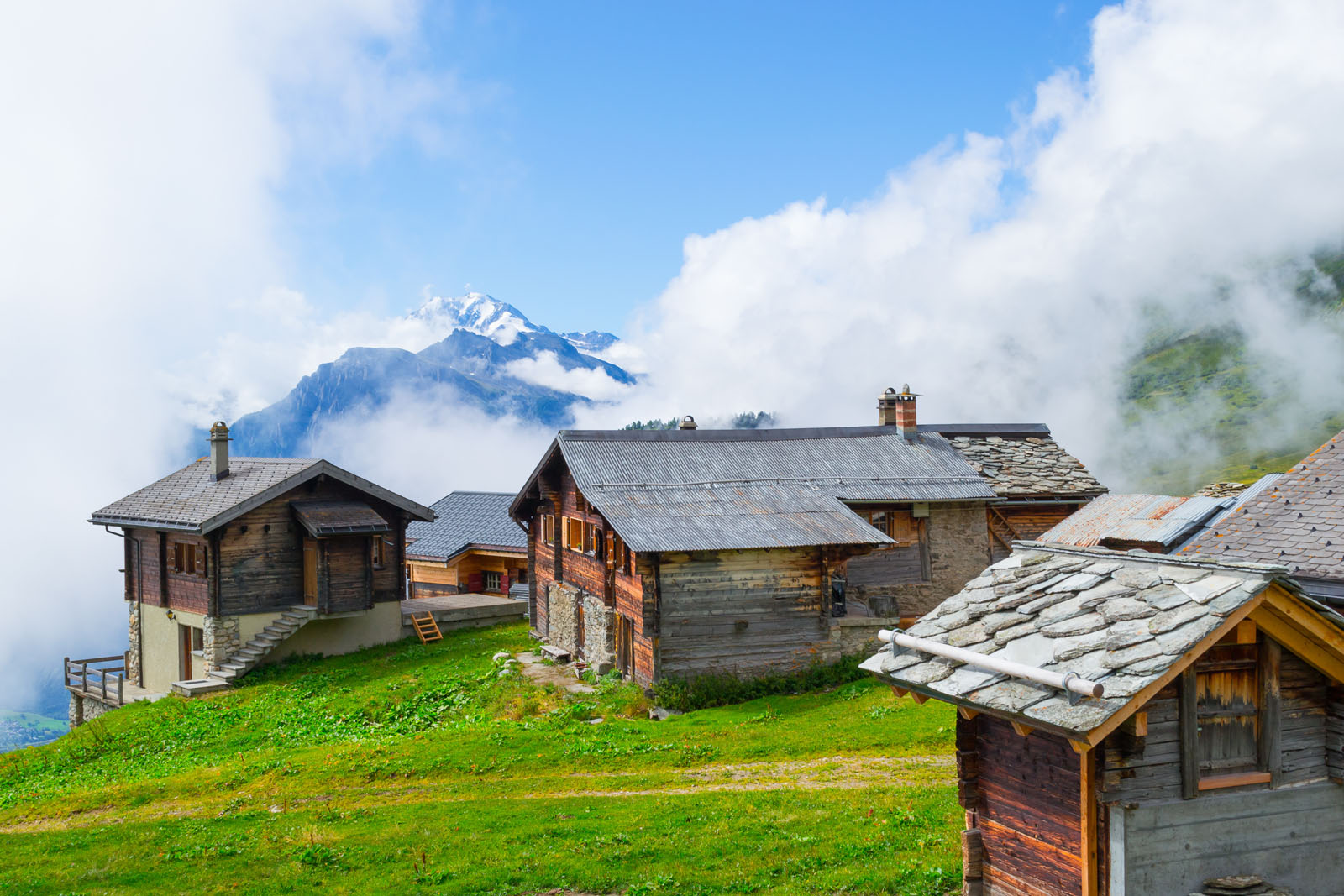 Belalp village in fog. Wooden houses and buildings in old style,