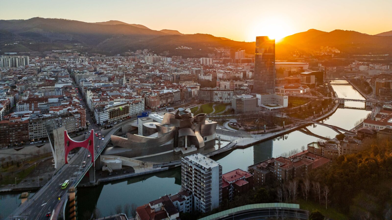 Bilbao cityscape with Guggenheim Museum, Nervión river and Iberdrola tower at sunset